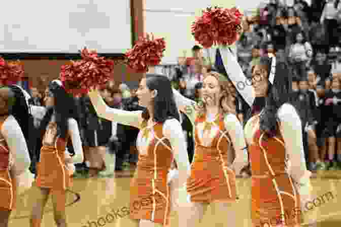 Garfield High School Students Gathered At A Pep Rally, Waving Red And Purple Pom Poms And Cheering Enthusiastically. Garfield High School Home Of The Bulldogs